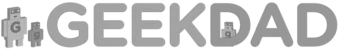 A grayscale logo for "GEEKDAD" featuring bold, rounded sans-serif capital letters. To the left of the text, there are two stylized robot figures—a larger one and a smaller one—representing the "Dad" and "Child" theme. A third, even smaller robot is nested within the opening of the letter "D". Each robot character has a lowercase "g" on its chest.
