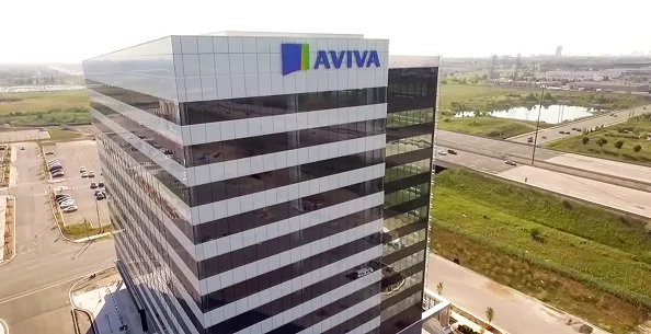 "An aerial view of a modern, multi-story office building with the Aviva logo displayed prominently near the top, surrounded by roads and green spaces."