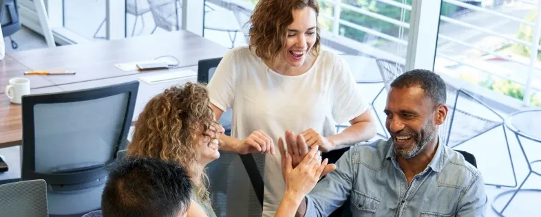 Diverse group of employees high fiving