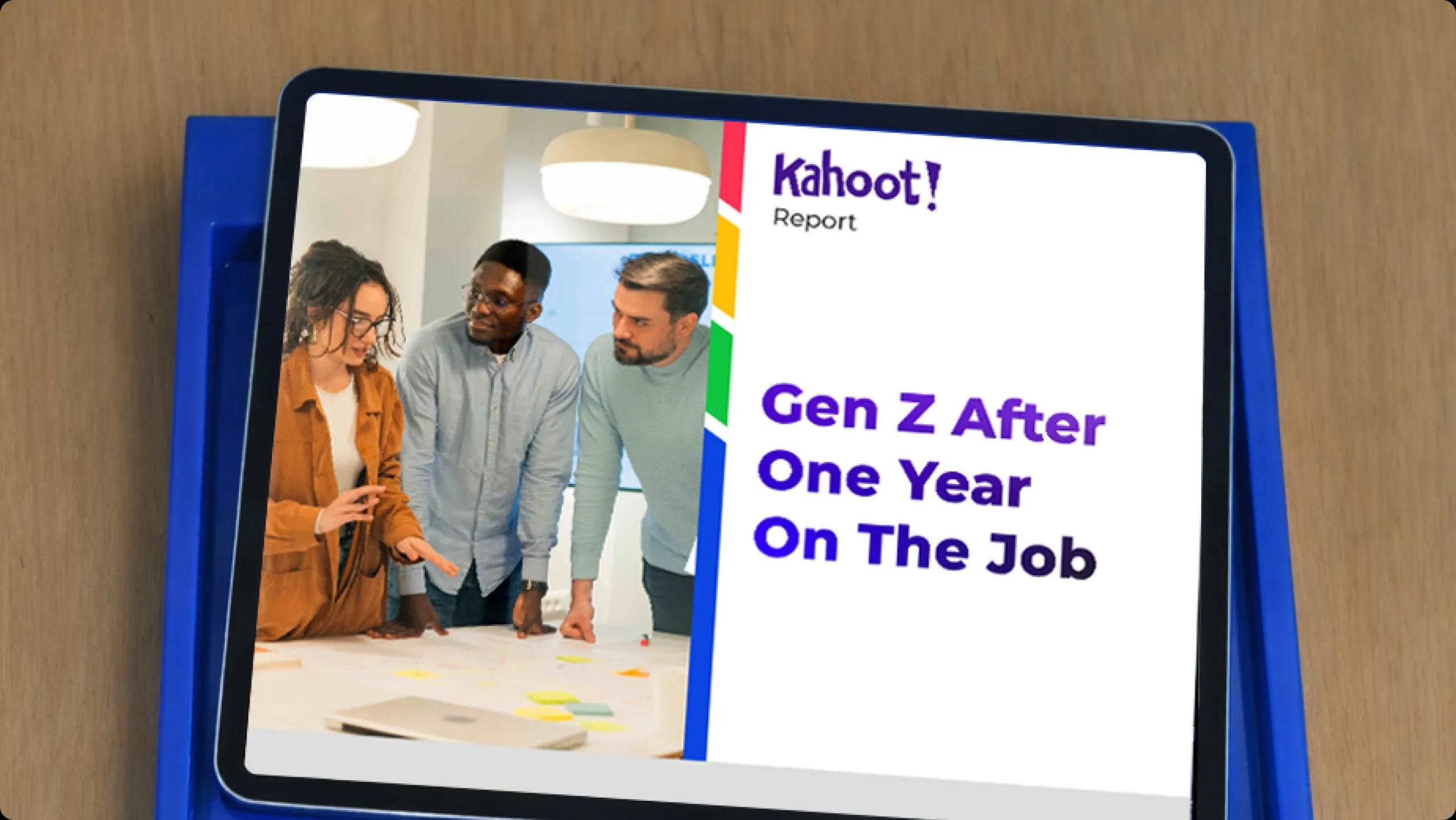 Tablet showing a Kahoot! report cover titled ‘Gen Z After One Year On The Job,’ next to a photo of three colleagues collaborating over a table with sticky notes.