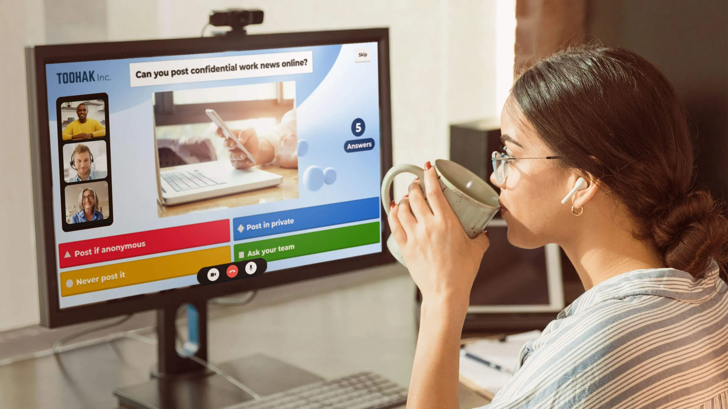 Woman drinking from a cup whilst doing training on Kahoot!