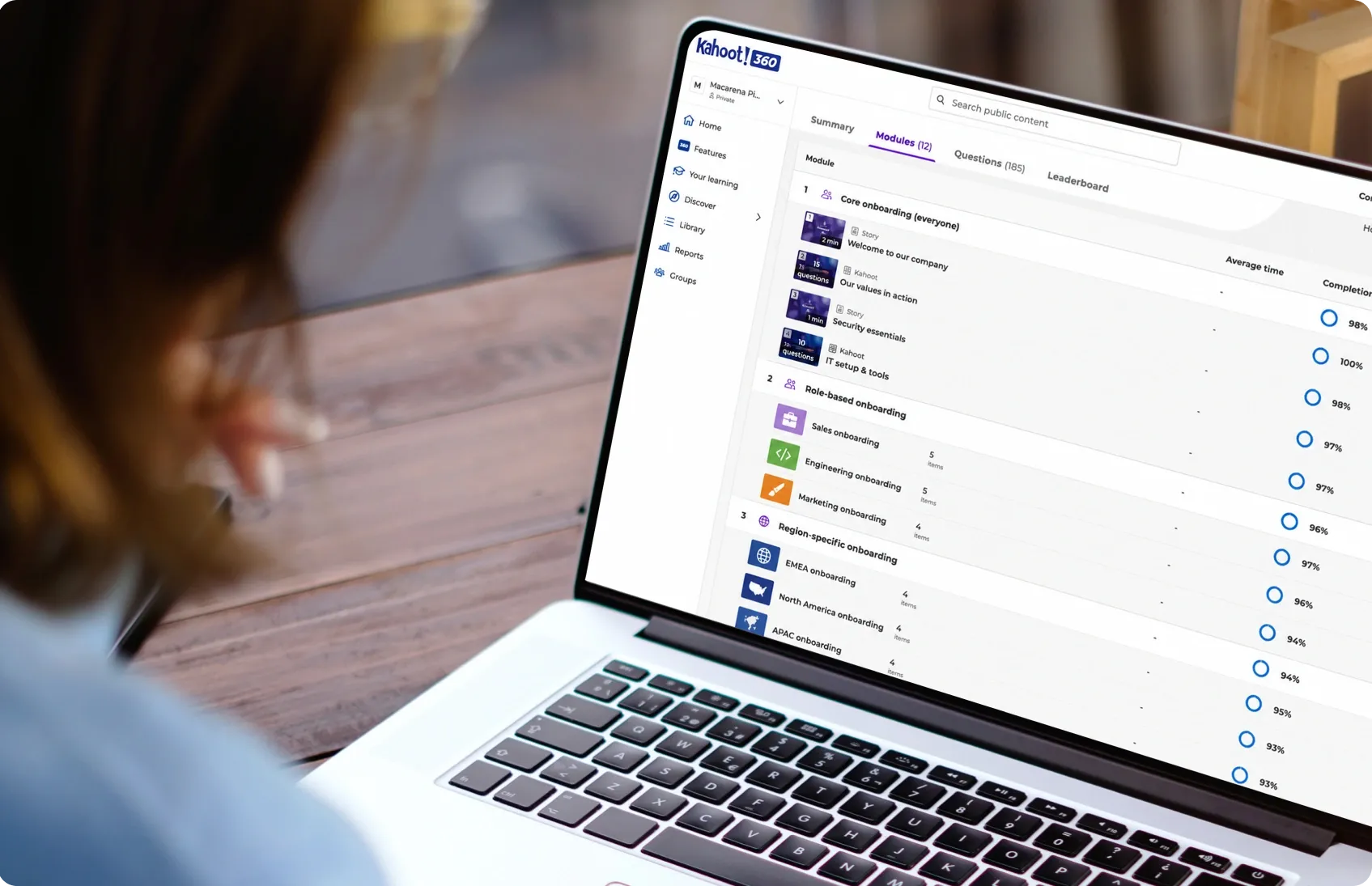 Person viewing a Kahoot 360 course with 12 modules covering core, role-based, and region-specific onboarding, with completion rates visible for each module